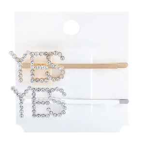 Detail of gold and silver YES letter hair clips with rhinestones on fashion jewelry card