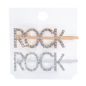 Detailed view of silver and gold ROCK rhinestone hair pins on a display card