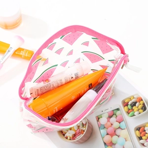 Transparent PVC makeup bag with pink watermelon print and zipper on a white desk