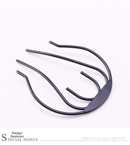 Three-prong black metal hair fork for DIY bun styling with a matte finish support tool