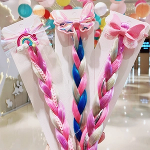 Detailed view of three colorful unicorn-themed braided hair extensions for girls