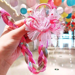 Detail of pink mesh flower hair tie with a long gradient braided wig for girls