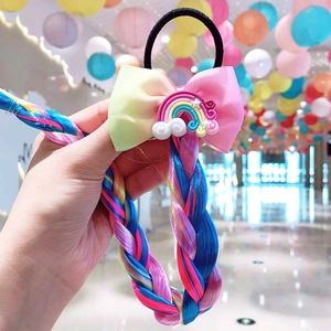 Detailed view of colorful gradient bow hair tie with long rainbow synthetic braid for girls