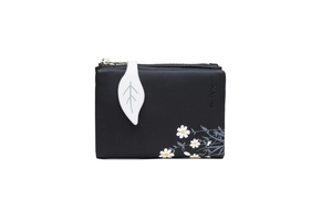 Close-up of black PU leather wallet with daisy print and white leaf zipper pull detail