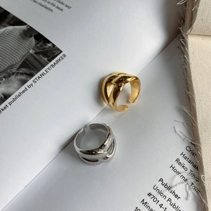 Detail of minimalist 925 silver irregular knotted rings in gold and silver finish