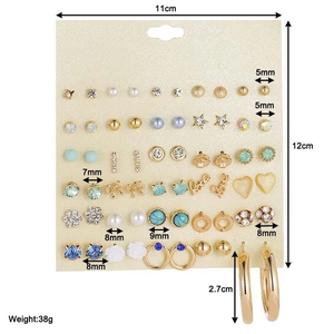 Detailed view of 30-pair stud earring set showing various sizes and diverse designs