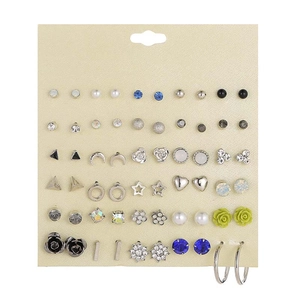 Detailed view of 25 pairs of mixed fashion stud earrings displayed on a texture card