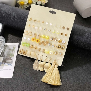 Detail of 30 pairs of gold-tone alloy floral and rhinestone earrings set on a card