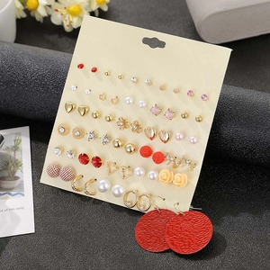 Macro shot of 30 pairs of floral and rhinestone alloy stud earrings on a display card