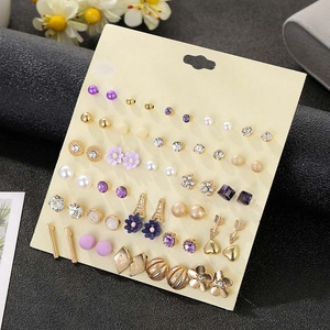 Macro shot of 30 pairs assorted flower and rhinestone stud earrings on a display card
