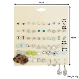 Detail showing 30 pairs of floral and rhinestone earrings set with size and weight info