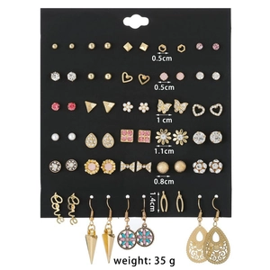 Detail showing 30 pairs of gold-plated alloy stud earrings with crystals and pearls
