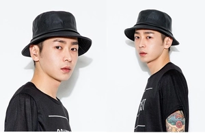 Side view of a black faux leather bucket hat with a sleek finish on a male model