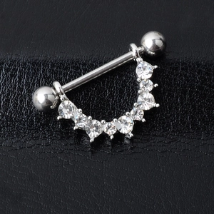 Surgical steel U-shaped nipple ring with sparkling crystals on black leather background