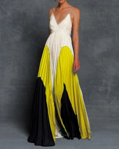 Detail of V-neck camisole dress featuring pleated color-block yellow and black skirt hem