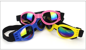 Close-up of foldable pet sunglasses with adjustable straps in pink, blue, and yellow colors