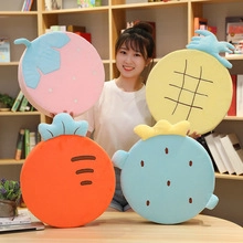 Group of colorful plush fruit pillows including strawberry and pineapple shapes