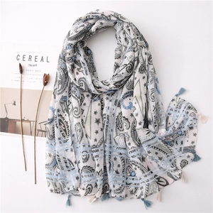Detail of light blue paisley cotton linen scarf with soft fringe and boho geometric patterns