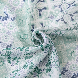 Close-up of light linen scarf with bohemian paisley print and airy floral texture