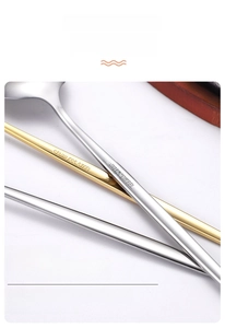 Detail of stainless steel cutlery set with brushed texture and gold-silver finish