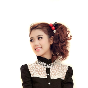 Japanese style cherry hair clip with bow decoration on a brown ponytail wig