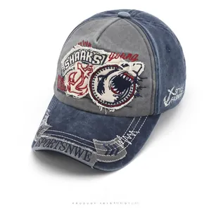 Detail view of washed vintage baseball cap with shark embroidery and distressed brim edge