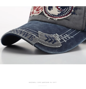 Macro detail of shark embroidery and vintage washed denim texture on a baseball cap