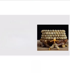 Macro detail of natural sandalwood prayer beads with distinct grain and woven tassel