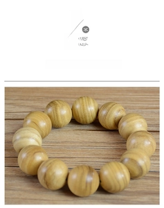 Detailed close-up of 108 Papua agarwood prayer beads showing natural wood grain texture