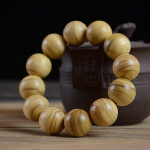 Natural Papua agarwood prayer beads bracelet displayed on a ceramic teapot with zen vibe