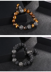 Macro shot of tiger eye and lava stone beads with antique silver mantra charms