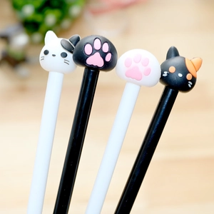 Close-up of cute cat head and paw toppers on creative cartoon gel pens for students