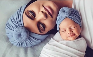 Matching mom and baby donut turban hats in soft grey-blue jersey fabric for newborn