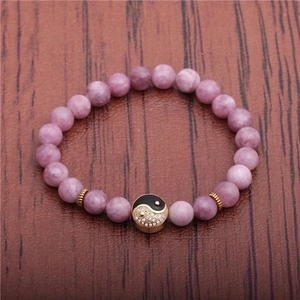8mm purple beaded bracelet featuring a gold Yin Yang charm on dark wood background