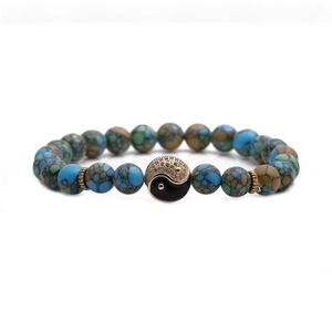 8mm natural agate bead bracelet with golden Tai Chi Yin Yang charm on white background