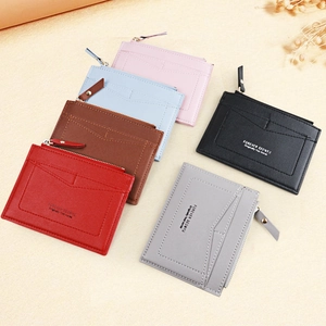 Detail view of colorful mini zipper purses with V-shaped stitching and multi-card slots