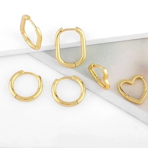 Polished gold geometric earrings set featuring heart, oval, and round hoop designs