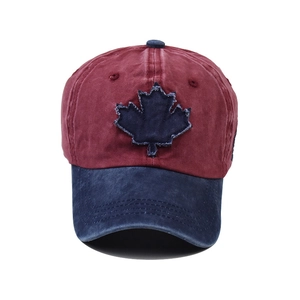 Macro detail of retro washed cotton baseball cap with embroidered blue maple leaf patch