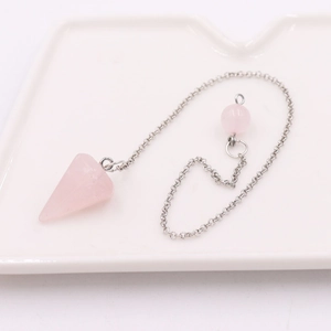 Pink quartz cone pendulum necklace with silver chain on a white ceramic tray
