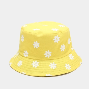 Detail of yellow cotton bucket hat featuring white daisy floral prints and clean stitching