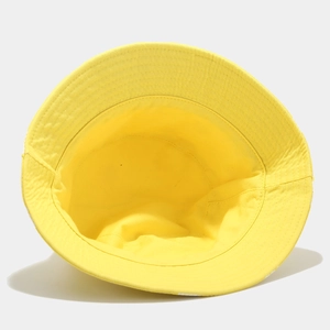 Detail view of the interior lining and stitching of the yellow cotton bucket hat