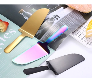 Three stainless steel cake servers in gold, black, and rainbow colors for professional baking