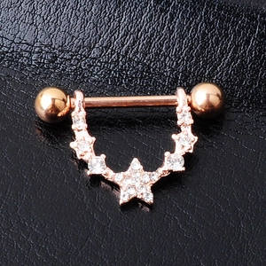 Rose gold starry moon nipple ring with sparkling crystals on black leather backdrop