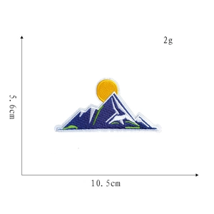 Detail view showing 10.5cm embroidered mountain patch with blue and yellow thread texture