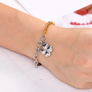 Two-tone gold and silver chunky chain bracelet with a four-leaf clover heart pendant charm