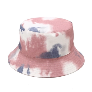 Close-up of tie-dye bucket hat showing pink and white cotton canvas texture and stitching