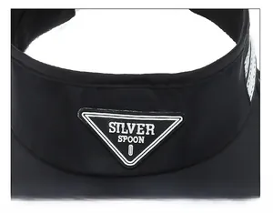 Detail of black sun visor featuring a Silver Spoon triangle patch and white side stripes