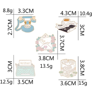Enamel book lover brooches featuring vintage typewriter and blue telephone designs
