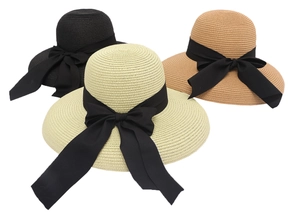 Detailed close-up of woven straw sun hats with black ribbons in three elegant colors