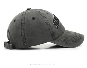 Detail view of washed dark grey baseball cap with black 3D embroidery and metal buckle